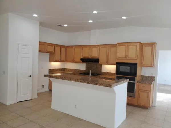 a kitchen with stainless steel appliances granite countertop a stove and a sink