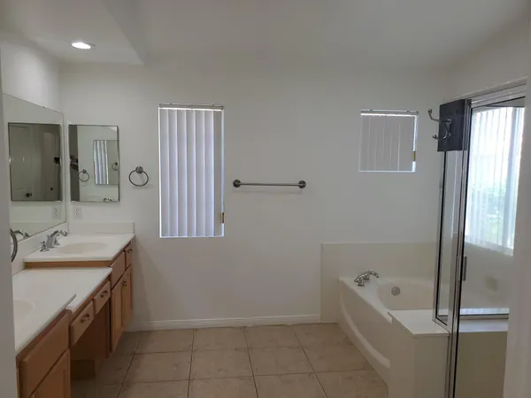 a bathroom with a tub sink and mirror