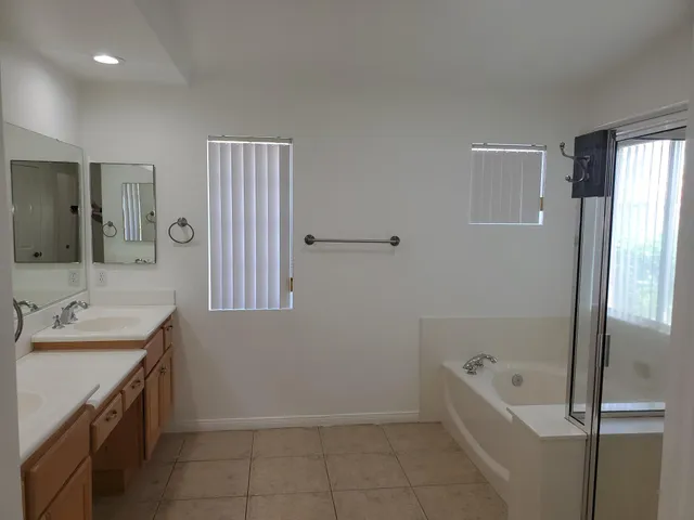 a bathroom with a tub sink and mirror