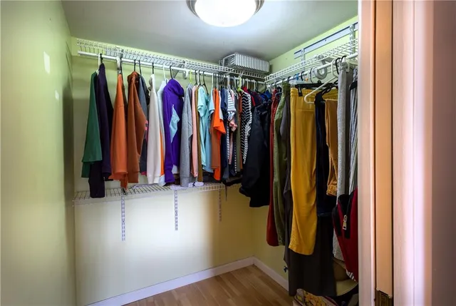 a view of walk in closet with clothes