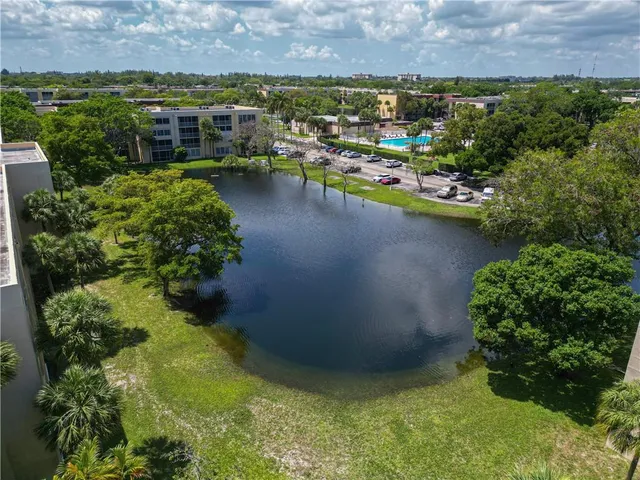 an aerial view of a houses with a lake view