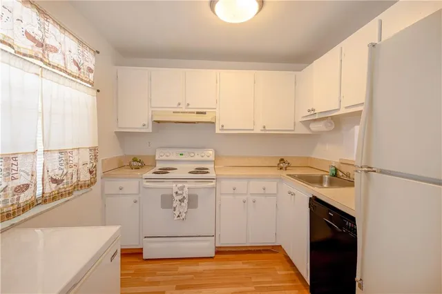 a kitchen with a sink a stove and cabinets