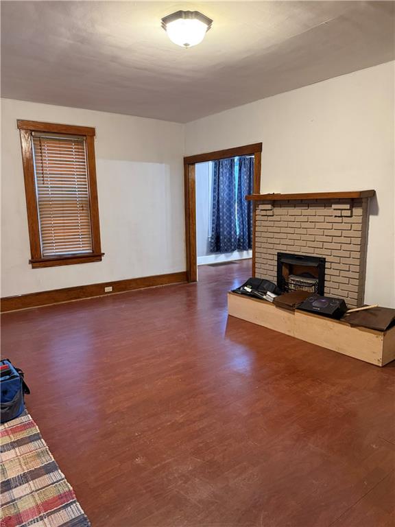 115 Lyon Avenue Butler, PA 16001 - Photo 9 of 32 a view of an empty room with wooden floor fireplace and a window