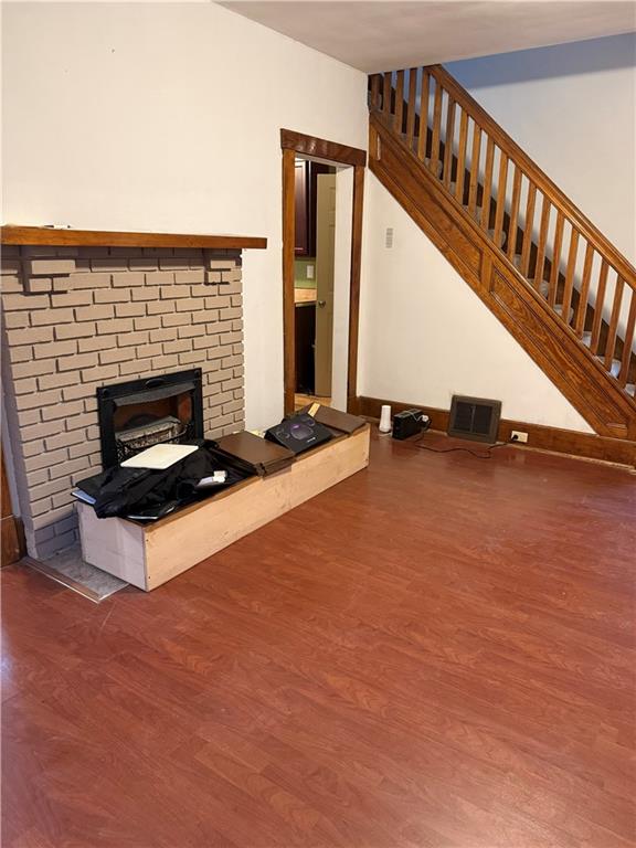 115 Lyon Avenue Butler, PA 16001 - Photo 10 of 32 a living room with fireplace furniture and a ceiling fan
