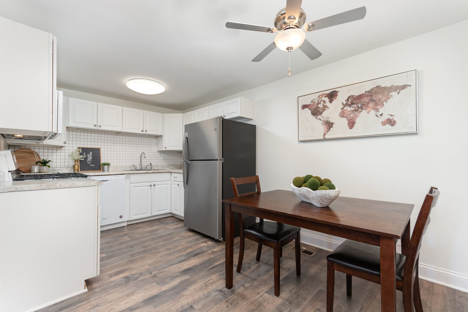 314 Covehill Court, Unit 314 Schaumburg, IL 60193 - Photo 5 of 18 a kitchen with a dining table cabinets and stainless steel appliances