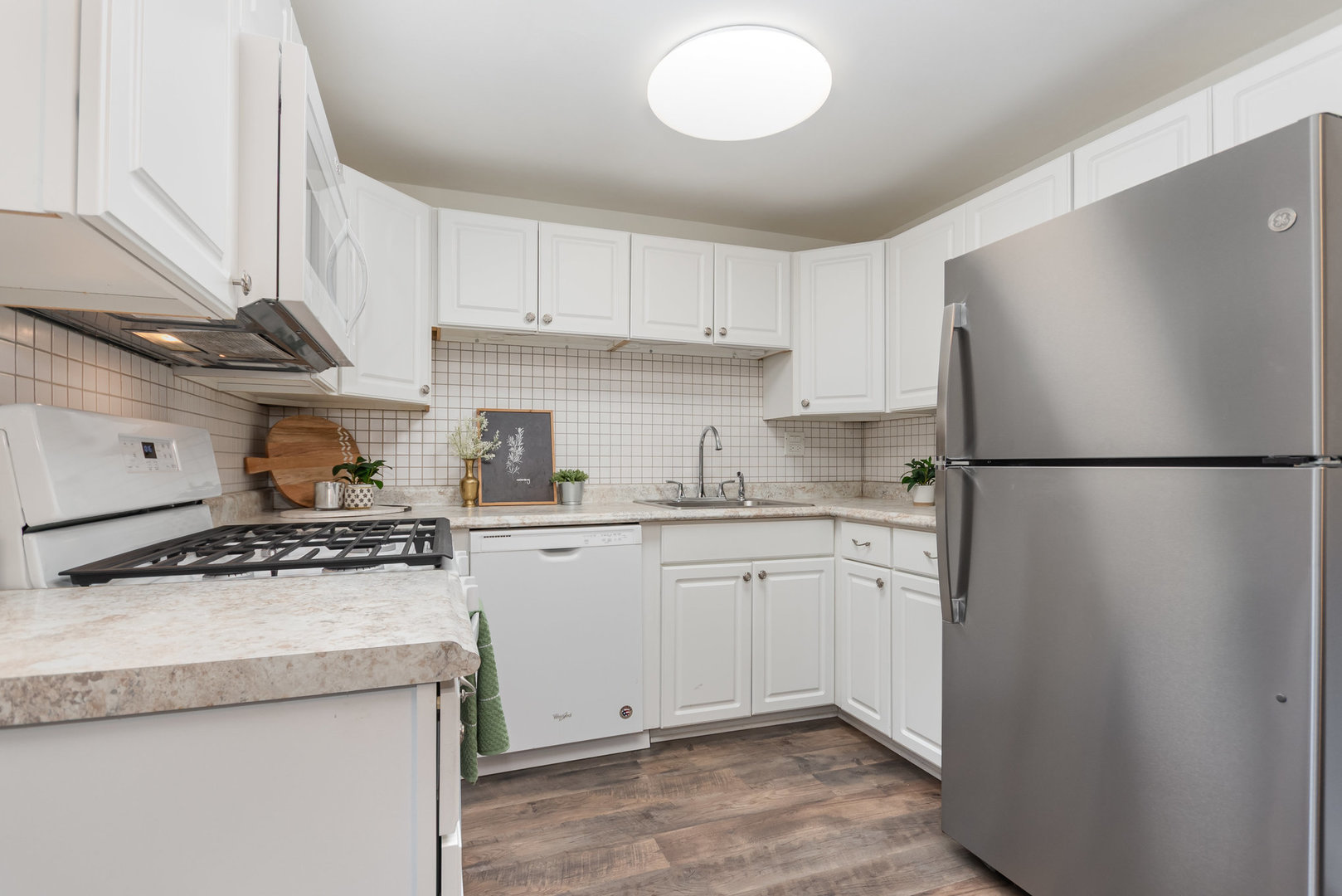 314 Covehill Court, Unit 314 Schaumburg, IL 60193 - Photo 6 of 18 a kitchen with stainless steel appliances granite countertop a stove a refrigerator and a sink