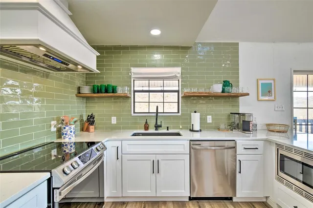 a kitchen that has a sink and a stove
