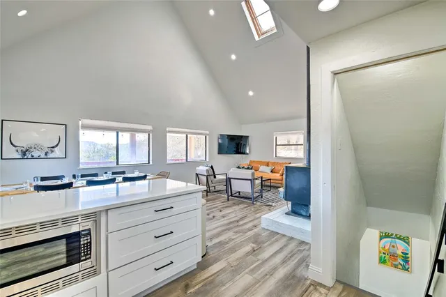 a kitchen with counter top space and painting on the wall
