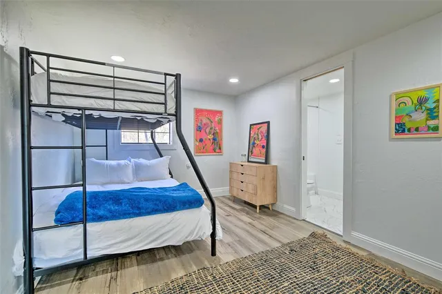 a bedroom with furniture and a wooden floor