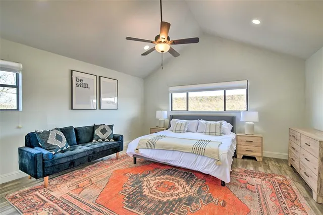 a bedroom with a bed couch and window
