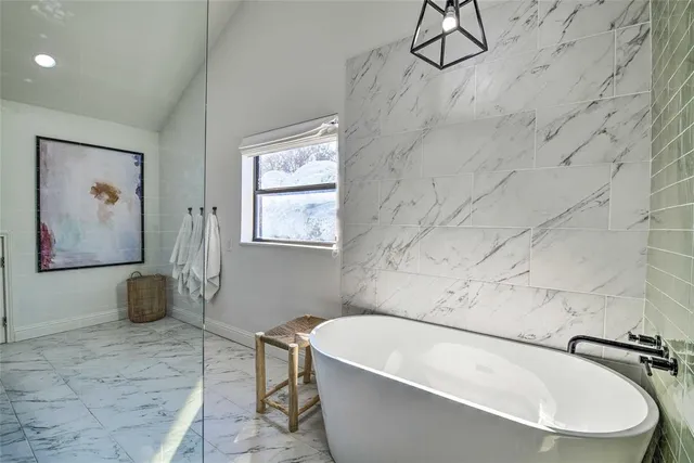 a bathroom with a bathtub and shower