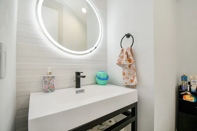 a bathroom with a sink and a mirror