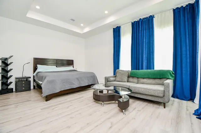 a bedroom with furniture and a wooden floor