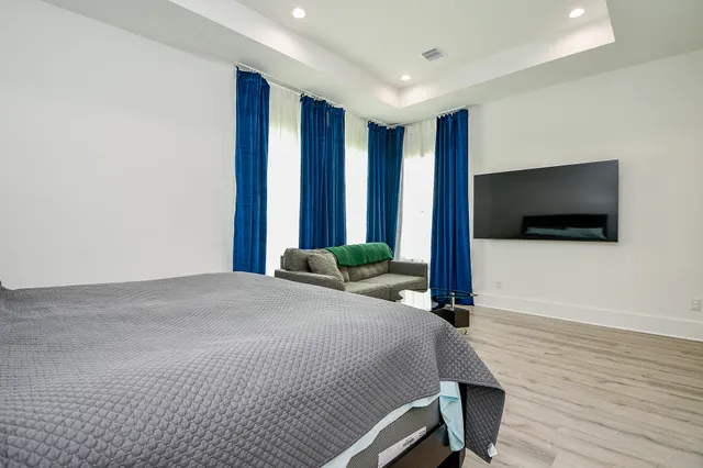 a bedroom with a bed and a flat screen tv