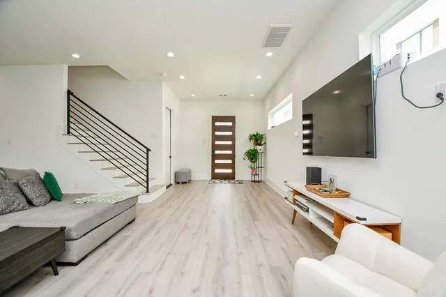 a hallway with a couch and a flat screen tv