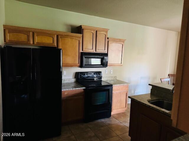 2600 East Springfield Place, Unit 58 Chandler, AZ 85286 - Photo 7 of 14 a kitchen with a stove and a refrigerator