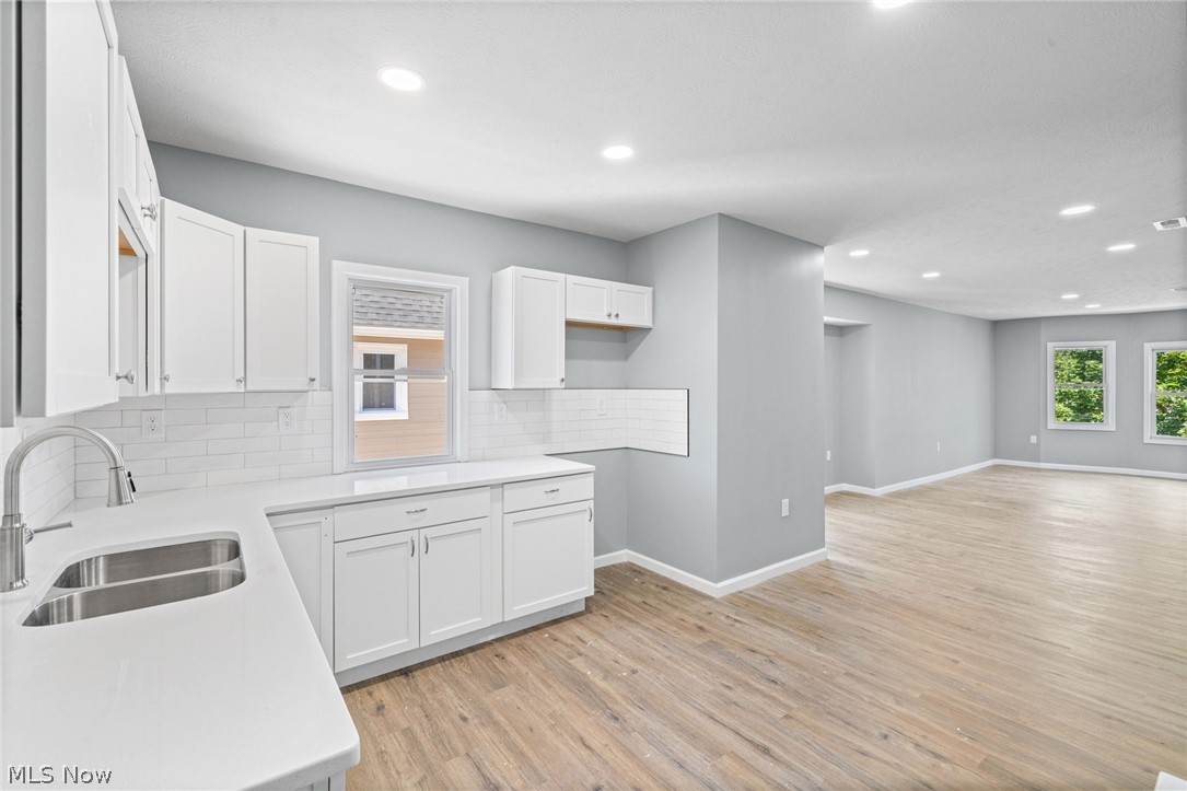 3925 Riverside Avenue Cleveland, OH 44109 - Photo 27 of 48 Contemporary kitchen with white shaker cabinetry, stainless steel undermount sink, and white subway tile backsplash