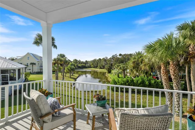 a view of a chairs and table in the balcony