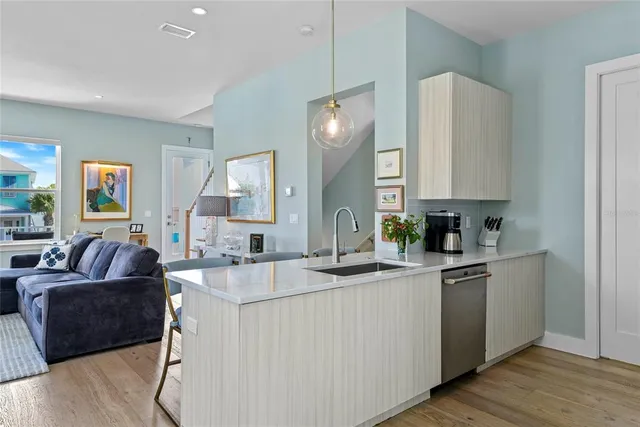 a kitchen with sink stove and refrigerator