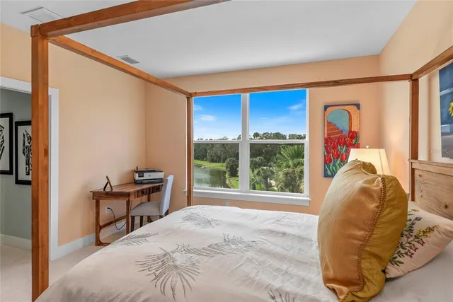 a bed sitting in a bedroom next to a window
