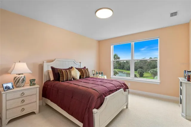 a bed sitting in a bedroom next to a window
