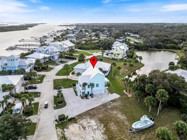 an aerial view of a city with lots of residential buildings ocean and mountain view in back