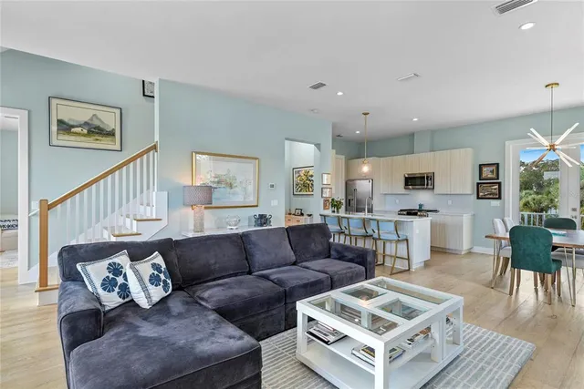 a living room with furniture kitchen view and a table