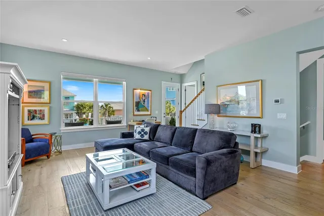 a living room with furniture and a painting on the wall