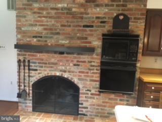 8491 Reservoir Road Fulton, MD 20759 - Photo 3 of 18 Enjpy the fireplace while cooking or enjoying food