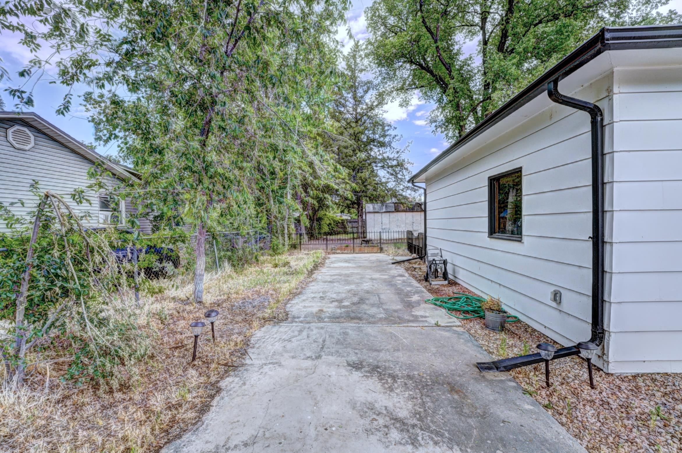 2894 Seely Road Grand Junction, CO 81503 - Photo 22 of 25 a view of a backyard with potted plants and large tree