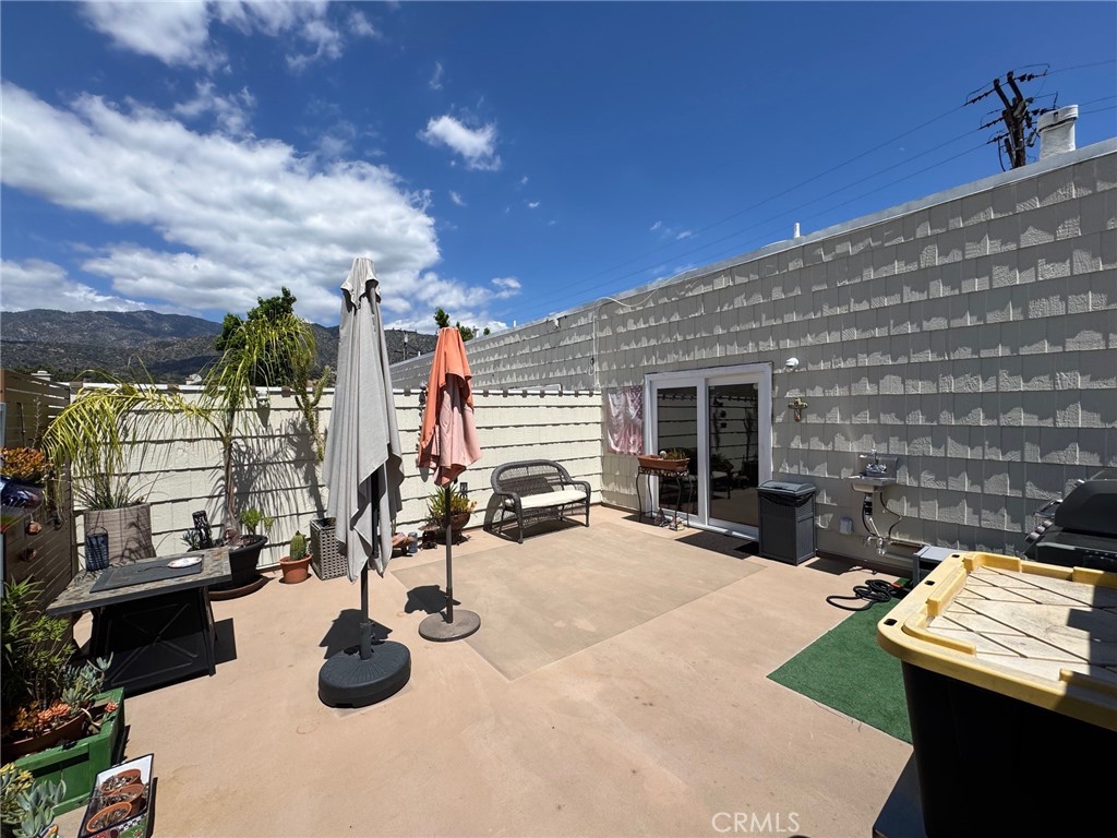 1434 Highland Avenue, Unit 13 Duarte, CA 91010 - Photo 14 of 14 a view of a patio with chairs and potted plants