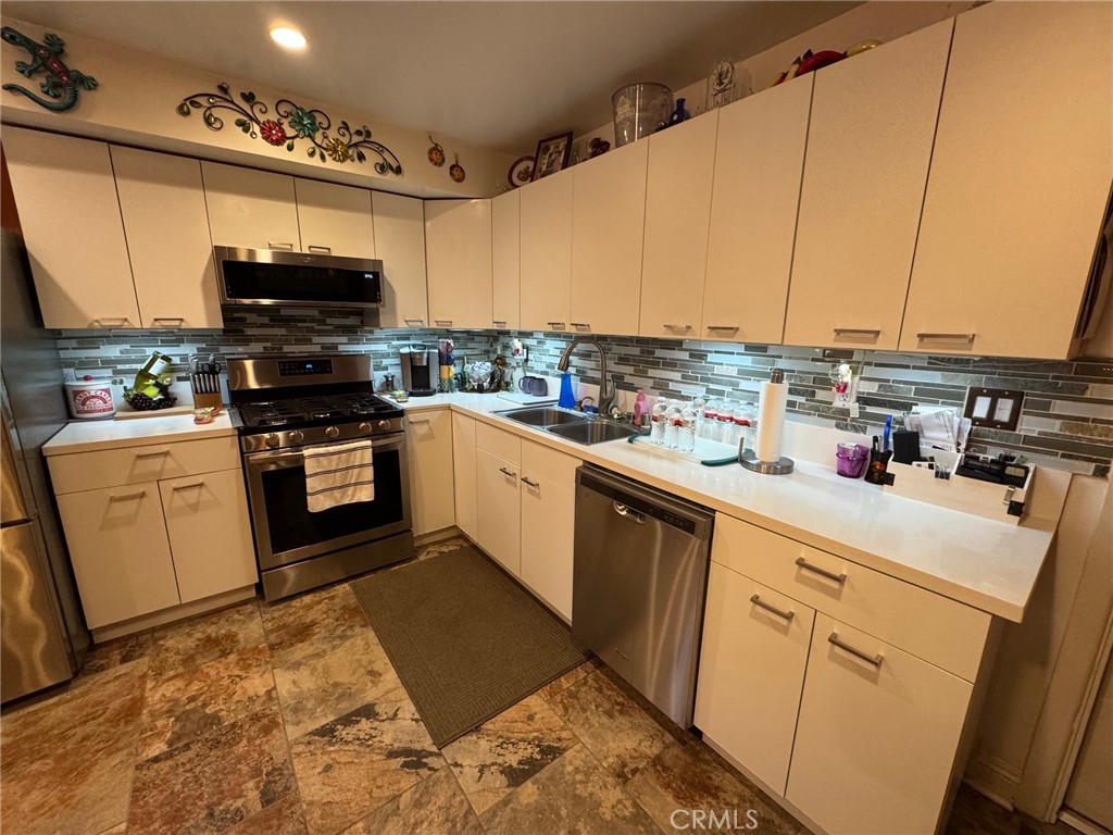 1434 Highland Avenue, Unit 13 Duarte, CA 91010 - Photo 8 of 14 a kitchen with stainless steel appliances a stove top oven a sink dishwasher and a microwave