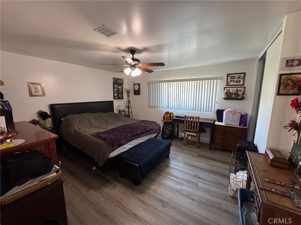 1434 Highland Avenue, Unit 13 Duarte, CA 91010 - Photo 9 of 14 a spacious bedroom with a bed a couch and a chandelier