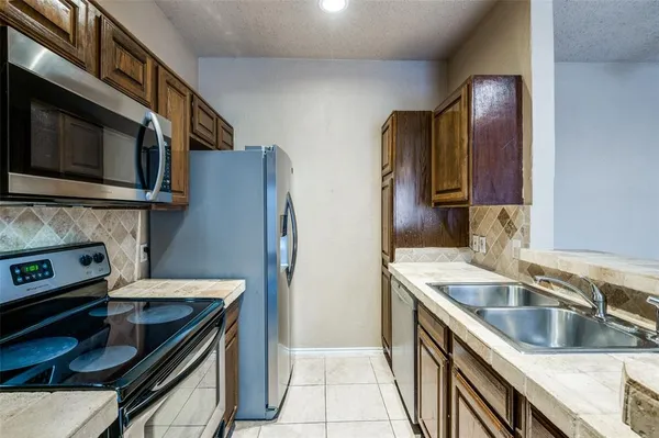 a kitchen that has a sink and a stove in it