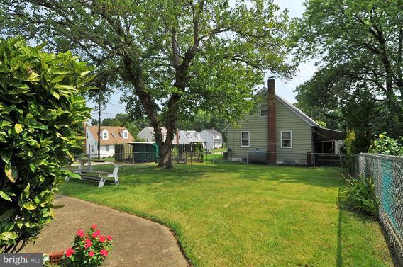 1253 Elm Road Baltimore, MD 21227 - Photo 17 of 29 a view of a house with a yard