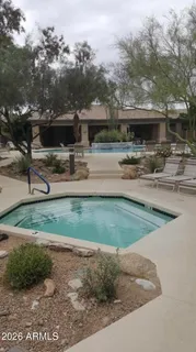 a swimming pool with outdoor seating and yard