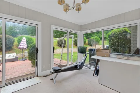 a view of a room with gym equipment and windows