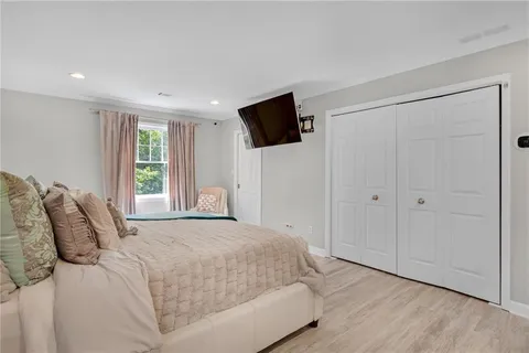 a bedroom with a bed and a flat screen tv