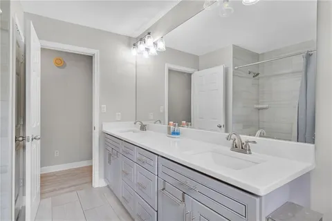 a bathroom with a sink double vanity and a mirror