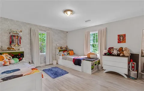 a bedroom with furniture and a window