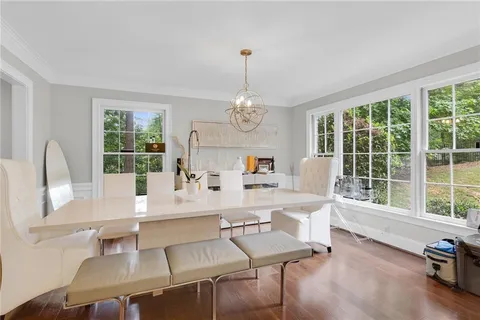 a very nice looking dining room with a large window and dining table