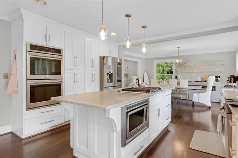 a kitchen with a stove a oven and a refrigerator