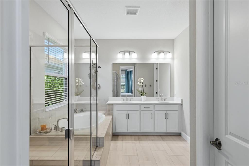 9268 Tequila Sunrise Drive Sarasota, FL 34241 - Photo 21 of 56 a bathroom with a double vanity sink and mirror