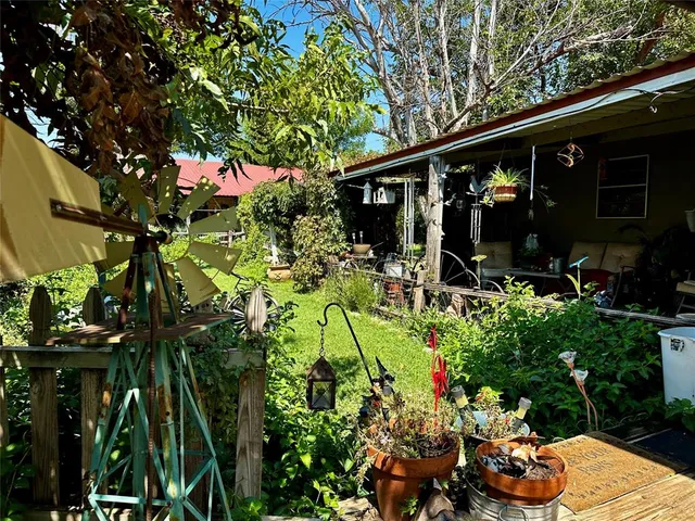 a view of a backyard with a small cabin