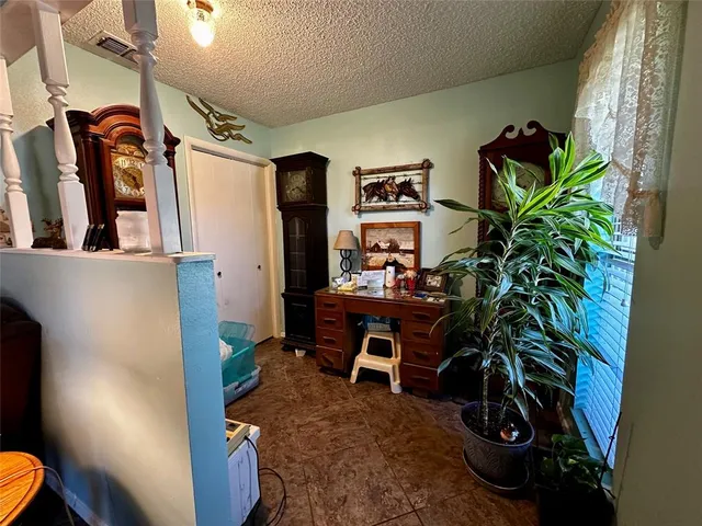 a dining room with furniture and a potted plant