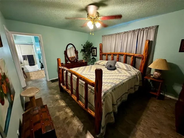 a bedroom with bed and a chandelier