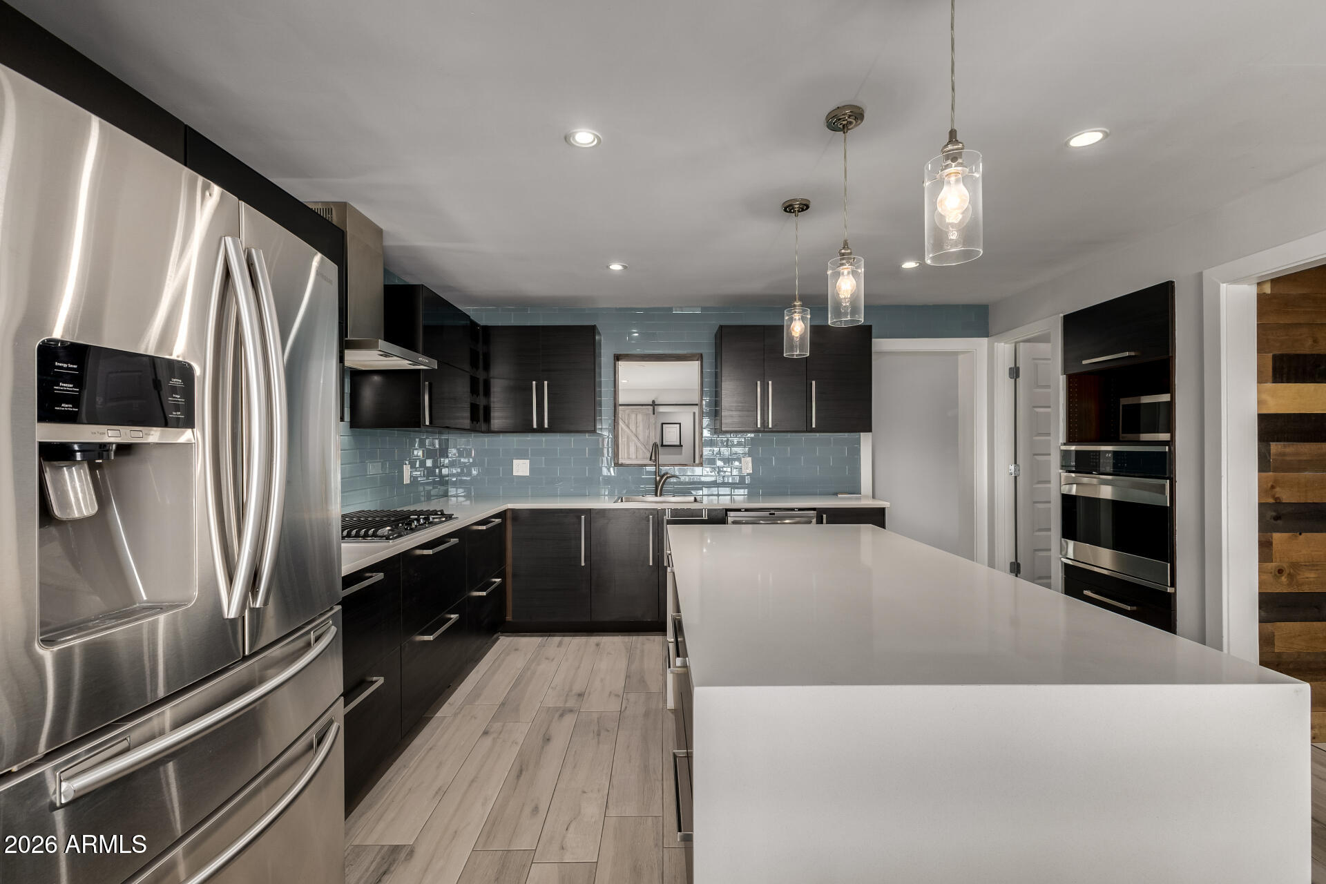 2402 North 37th Street Phoenix, AZ 85008 - Photo 11 of 44 a large kitchen with stainless steel appliances kitchen island a large counter tops a stove a refrigerator and cabinets