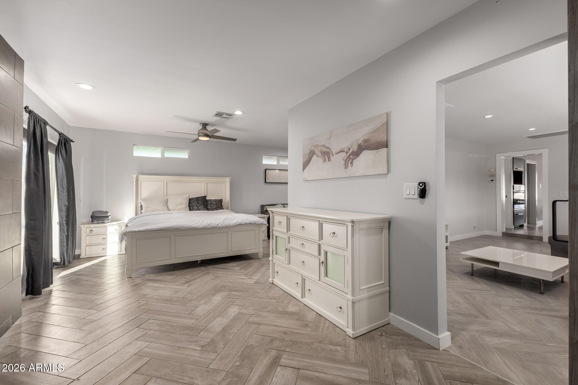 2402 North 37th Street Phoenix, AZ 85008 - Photo 14 of 44 a spacious bedroom with a bed a mirror and furniture