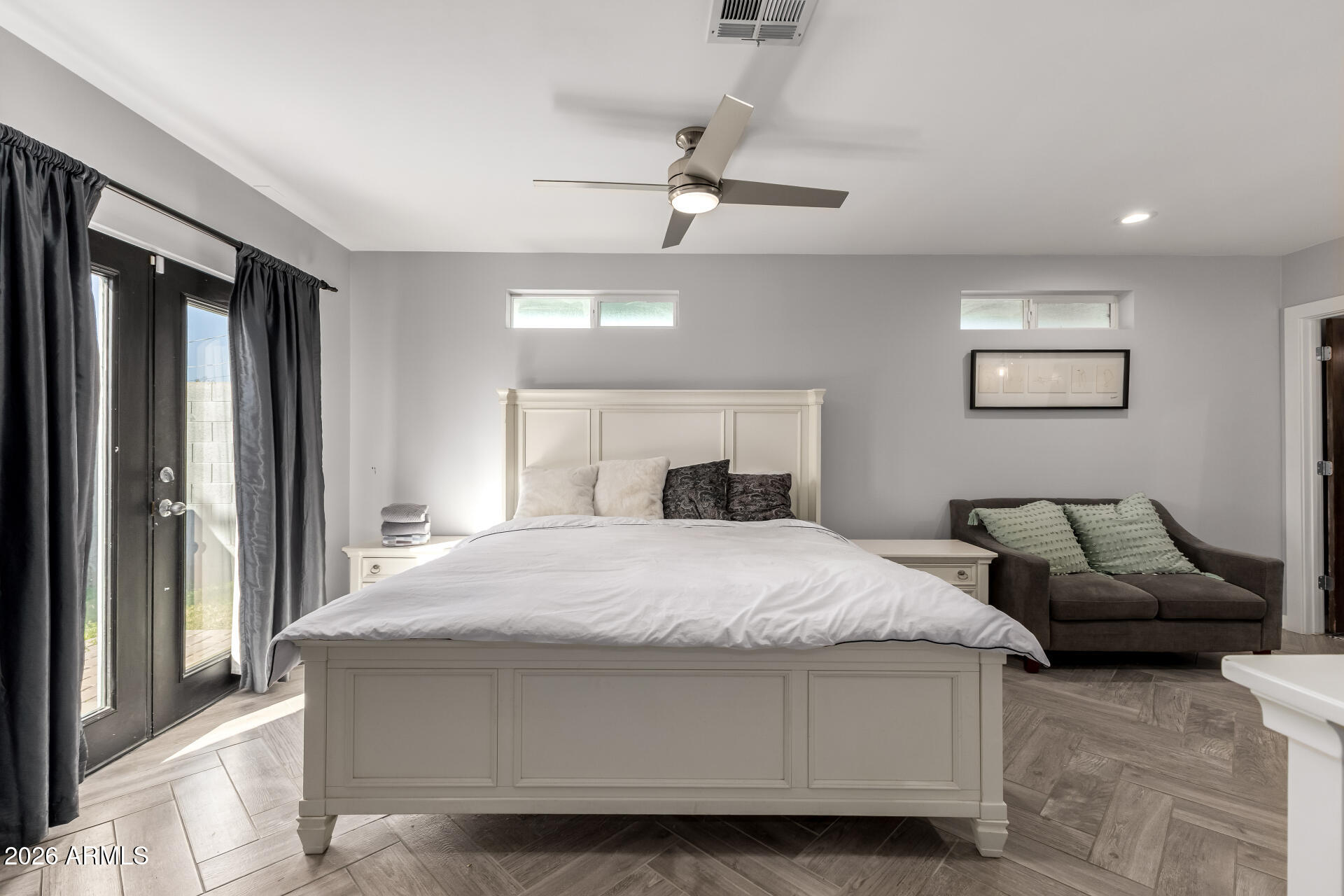 2402 North 37th Street Phoenix, AZ 85008 - Photo 15 of 44 a bedroom with a large bed and a chandelier