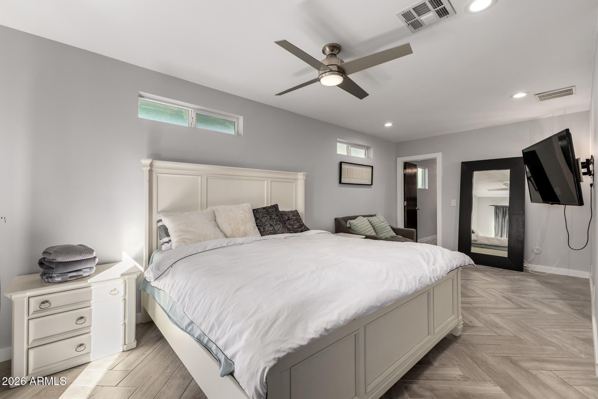 2402 North 37th Street Phoenix, AZ 85008 - Photo 16 of 44 a bedroom with a large bed and a chandelier